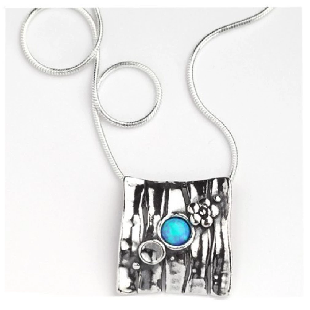 square pendant with small designs and round opal stone